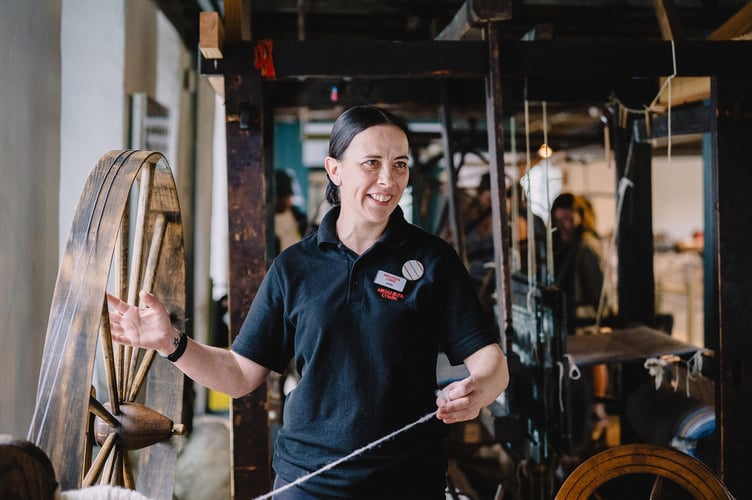 Craft technician Jody Smart spinning at the National Wool Museum