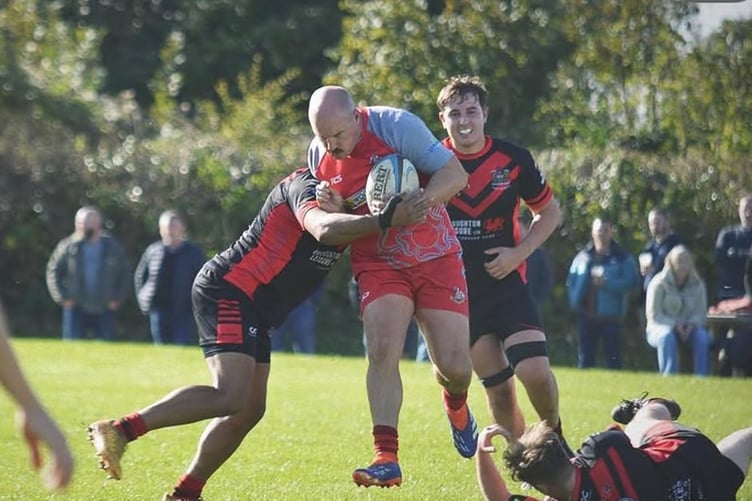 Pembroke centre Lewis Davies breaking through defenders for his second try