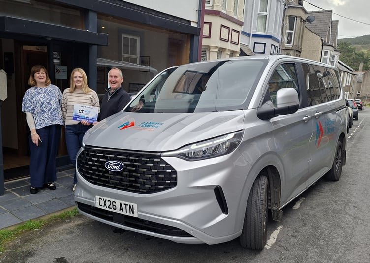 Michelle Clarke, Community Transport Association, and Lowri Silverwood-Owen and Huw Ceiriog from O Ddrws i Ddrws community transport scheme with the latest addition to the fleet of vehicles