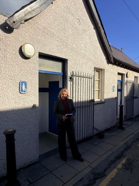 Elizabeth Evans in front of Masons Row toilets in Aberaeron