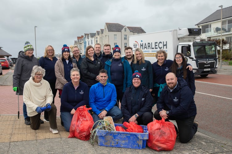 Harlech Foodservice staff take part in the beach clean at Pwllheli . Pictured (front centre) Mike Clisham of Harlech food service and other staff members of Harlech foodservice along with South Caernarfonshire Soroptimists members Sara Williams ((back 1st left) and Marjorie Griffin (Front 1st left).